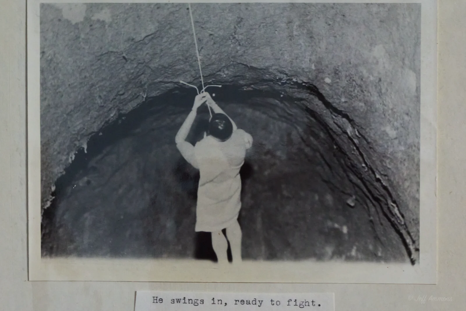 Heracles swings into the cave on a rope, ready to confront the lion.